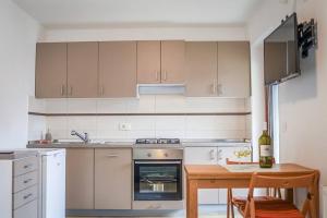 a kitchen with a stove and a table with a bottle of wine at Place of Wonder in Bohinj