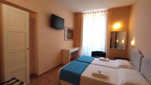 Postel nebo postele na pokoji v ubytování Hotel Rita Major
