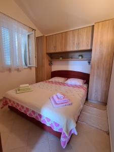 Postel nebo postele na pokoji v ubytování Apartmani Božana Viganj