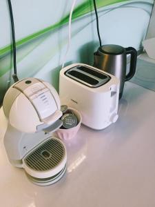 a toaster and toaster sitting on top of a counter at Luxury Panoramic Seaside Apartment in Burgas City