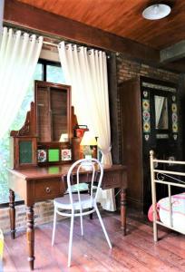 a bedroom with a desk and a bed with a mirror at NILA HOUSE, Sharia Family Home Stay in Jakarta