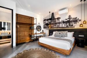 a bedroom with a large bed and a bathroom at Villa Australis in Kerobokan +40 photos