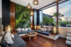 a living room with a couch and a large window at Villa Australis in Kerobokan