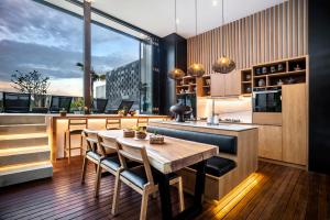a kitchen with a table and chairs and a large window at Villa Australis in Kerobokan