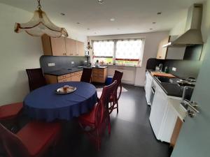 a kitchen with a table with a blue table cloth on it at Ferienwohnung Inge in Waldsassen