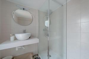 a bathroom with a shower with a sink and a mirror at Sa Marineta in Porto Cristo