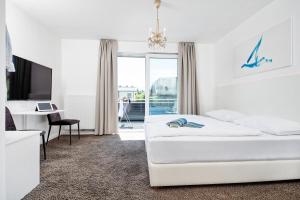 Postel nebo postele na pokoji v ubytování Hotel Velden - 24 Checkin Zimmer im Zentrum