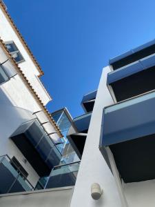 a building with blue balconies on the side of it at Hotel TossaMar in Tossa de Mar