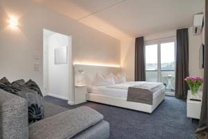 Кровать или кровати в номере Hotel 24 Checkin Velden
