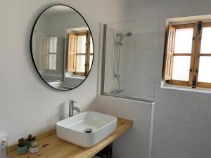 a bathroom with a sink and a mirror at El desván de Bruno in Villalobos +11 photos