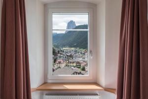 a window with a view of a mountain at Villa Martiner Apartments Alex in Ortisei