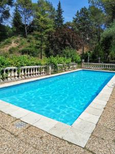 a swimming pool with blue water at Appartement de 3 chambres avec piscine partagee jardin amenage et wifi a Berre les Alpes in LʼEscarène