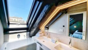 a bathroom with two sinks and a large window at Hotel Sant Agustí in Barcelona +46 photos