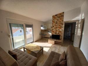 a living room with a couch and a table and a tv at Villa Elina Ulcinj Montenegro in Donji Štoj