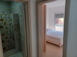 a bedroom with a walk in shower and a bed at Villa Elina Ulcinj Montenegro in Donji Štoj