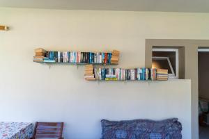 a shelf on the wall with dvds at Lambrini Studios in Parga