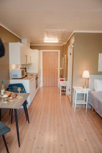 a room with a kitchen and a living room at Åkrafjordtunet Apartments in Teigland +6 photos