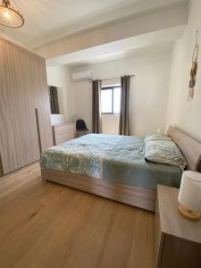 a bedroom with a bed and a desk and a window at Rabat Falcon Apartment in Rabat