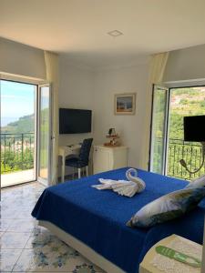 a bedroom with a bed and a television at Nonno Francesco B&B in Ravello