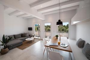 a living room with a table and a couch at Summer Vibes Tsoukalades in Tsoukaladhes