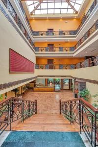 an empty lobby with a staircase and a large window at Club Mahindra Snow Peaks Manali in Manāli