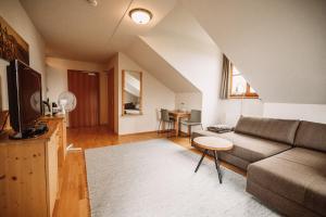 a living room with a couch and a table at Weinhotel Maitz Wolfgang in Ratsch an der Weinstraße