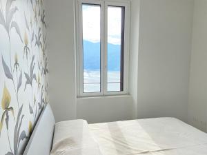 Postel nebo postele na pokoji v ubytování Villa Nova apartment in Moltrasio – Lake Como