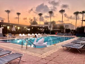 a swimming pool with swans in a resort at Carina Hotel Apartments in Ayia Napa