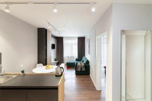 a kitchen with a sink and a living room at AUSTRIAN APART HOTEL in Lviv