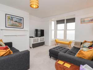 a living room with two couches and a tv at Fairlight View in Folkestone