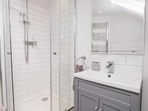 a white bathroom with a sink and a shower at Fairlight View in Folkestone +21 photos