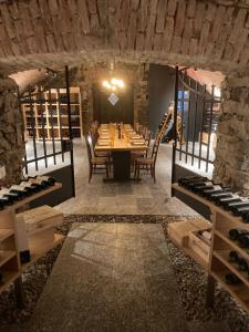 a dining room with a table and a wine cellar at Hotel Ristorante Grotto Serta in Lamone