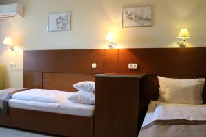 Postel nebo postele na pokoji v ubytování Hotel Villa Pax