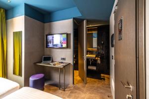 a room with a desk with a laptop on it at HD8 Hotel Milano in Milan