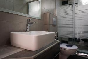 a bathroom with a sink and a toilet at Haus Viktoria 2 in Limenas