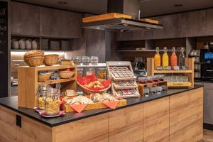 a bakery counter with a lot of different types of food at Hotel Bären am Bundesplatz in Bern
