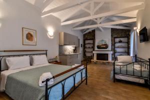 a bedroom with a large bed and a kitchen at OpenSea Villa Private beach & tennis court in Thermisía