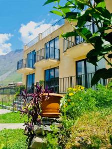a building with a bench in front of it at Hotel Horizon Kazbegi in Kazbegi