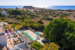 an aerial view of a house with a swimming pool and the ocean at Villa Mary's Holiday House in Pefki Rhodes