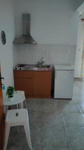 a kitchen with a sink and a stove and a table at Vigla House in Sykia Chalkidikis