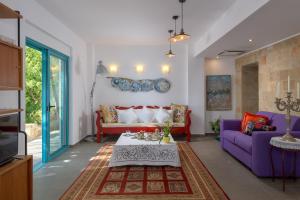 a living room with a purple couch and a table at Villa Mary's Holiday House in Pefki Rhodes