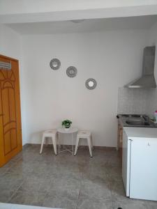 a kitchen with a table and two stools in it at Vigla House in Sykia Chalkidikis