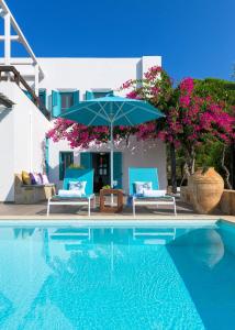 a swimming pool with two chairs and an umbrella at Villa Mary's Holiday House in Pefki Rhodes +28 photos