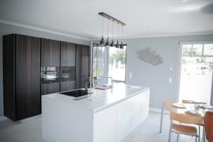 a kitchen with a white counter top and wooden cabinets at Ferienhaus Emma in Kramerhof