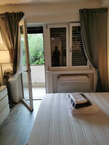 a bedroom with a bed and a window and a door at Girasole Trento in Trento