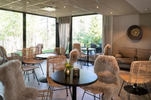a room with tables and chairs with animals on them at Lapland Hotels Sky Ounasvaara in Rovaniemi