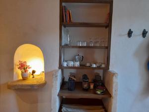 a room with a shelf with a light on it at Les Guillaume Rey in Oppède