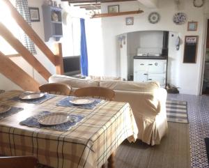 a dining room with a table and a kitchen at Dairy Cottage in Cockley Cley