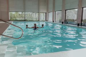 a woman is laying in a swimming pool at Ons Buiten in Oostkapelle