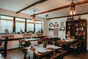 a dining room with tables and a large window at Etno Garden Apartments in Plitvička Jezera